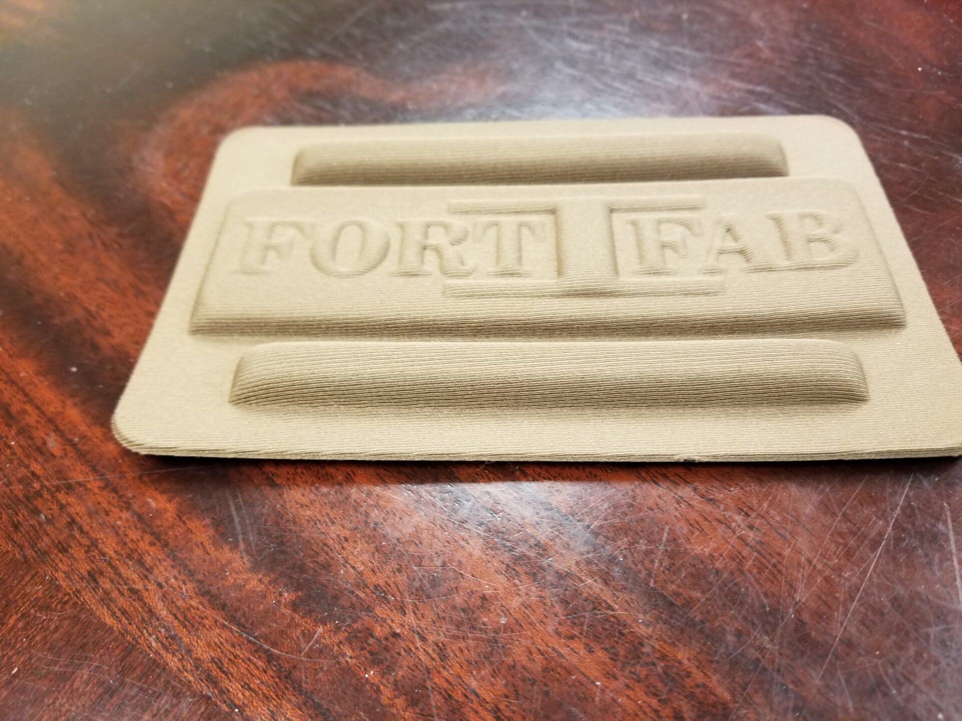 Thermoformed/Compression molded part with Fort Fab logo